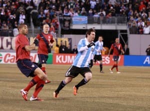 Messi startuje do piłki, przygląda się Onyewu.